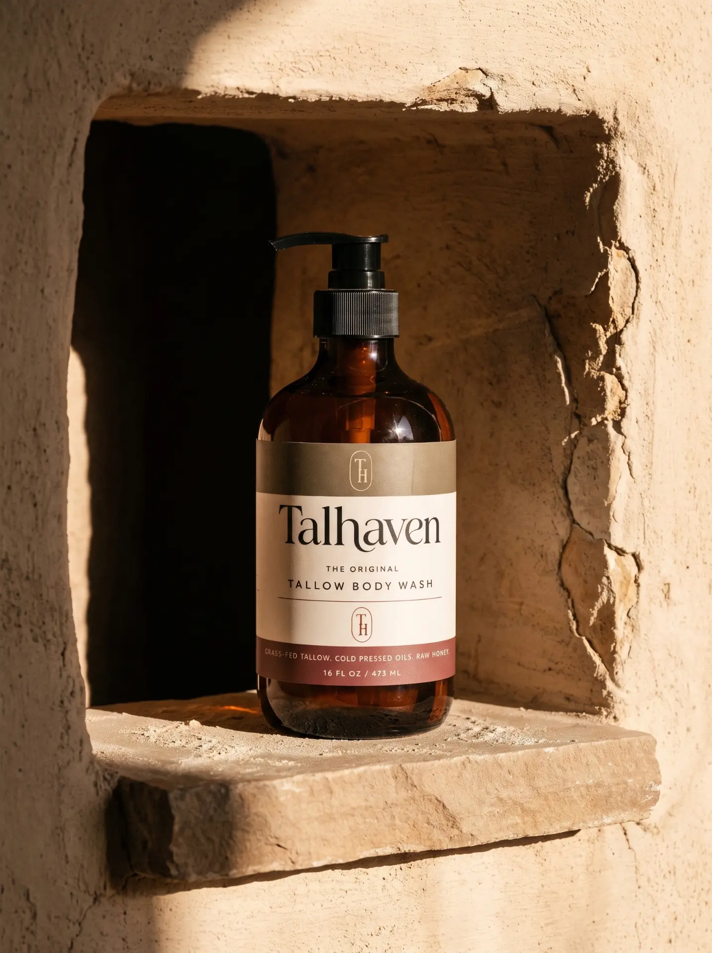 Talhaven tallow body wash resting in a warm plaster niche